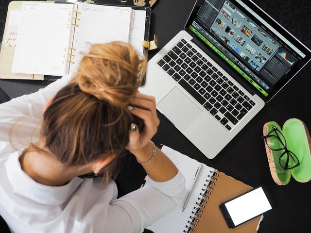 Stressed woman working at computer